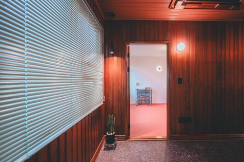 a hallway with a door and a plant in a room at Chungking Mansions Busan in Busan