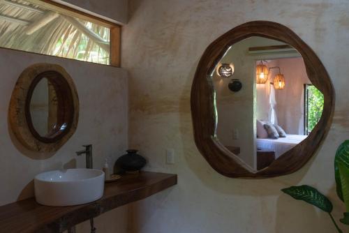 a bathroom with a sink and a mirror at Casa Mariposa Beach Hotel in Tierra Blanca