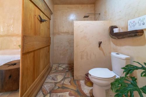 a bathroom with a toilet and a sink at Casa Mariposa Beach Hotel in Tierra Blanca
