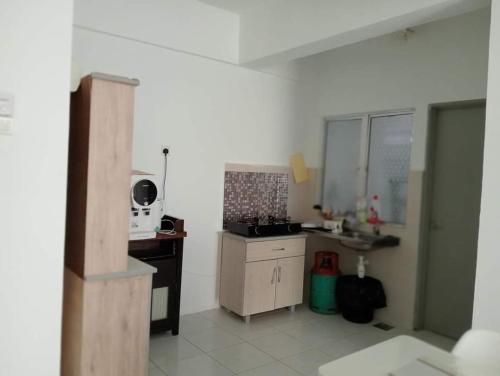 a kitchen with a stove and a sink in it at EM Camar Seaview Homestay at Sutra Villa2 in Kuantan