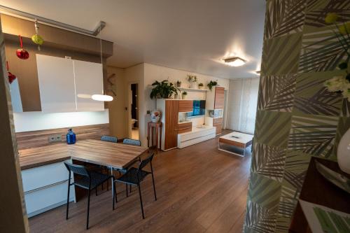 a kitchen and dining room with a table and chairs at A-Apartment Wolfsburg in Wolfsburg