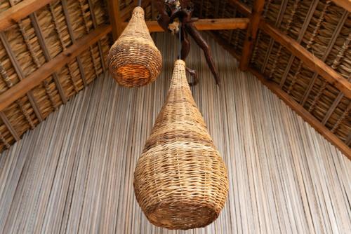 two wicker baskets on the floor of a room at Casa Mariposa Beach Hotel in Tierra Blanca