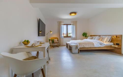 a bedroom with a bed and a table and chairs at Studio Percan in Premantura
