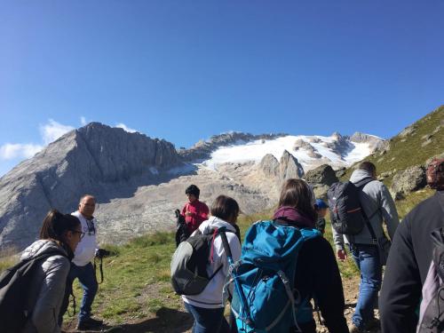 a group of people walking on a mountain at Fedaia Joy B&B in Canazei