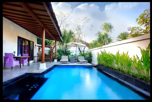a swimming pool in the middle of a house at One Bedroom Private Pool Classic Villa in Kuta