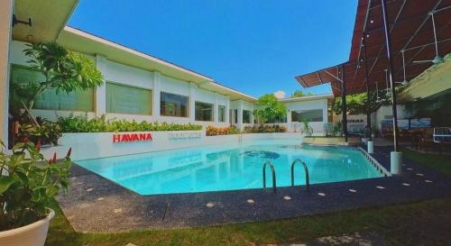 a swimming pool in front of a building at One Bedroom Private Pool Classic Villa in Kuta