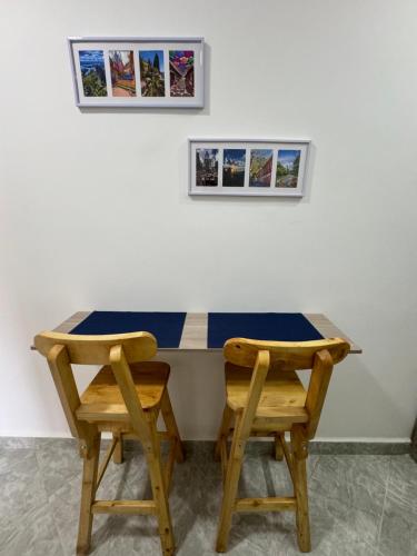 a table with two chairs and two pictures on the wall at Casa San Miguel 101 in Medellín