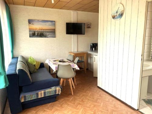 a living room with a couch and a table at Ferien-Bungalow im Seebad UeckermündeOT Bellin in Ueckermünde