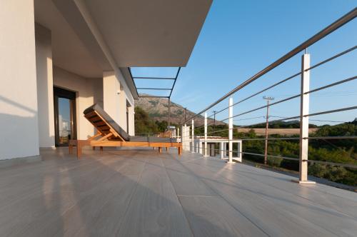 a balcony with a bench and views of a mountain at Boutique apartments Myesis in Samothráki