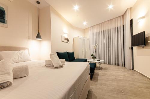 a hotel room with a large bed and a couch at Boutique apartments Myesis in Samothráki