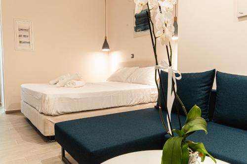 a hotel room with a bed and a couch at Boutique apartments Myesis in Samothráki