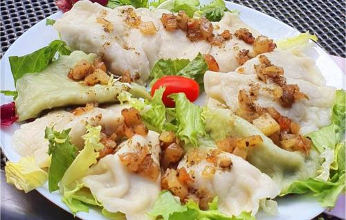 a white plate of food with lettuce and meat at Cozy Home In Sulnowo With Sauna in Sulnówko