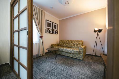 a living room with a couch and a table at Pension Relish in Rajecké Teplice
