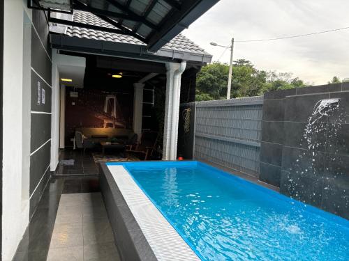 a swimming pool in the backyard of a house at Araas Boutique House for Family Stay ONLY in Sungai Buluh