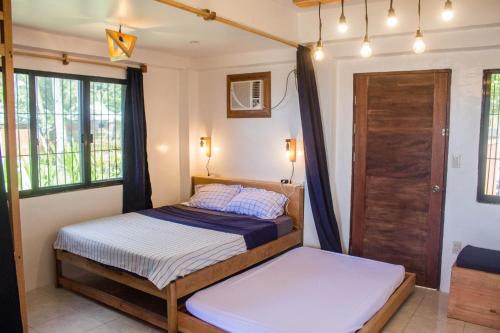 Postel nebo postele na pokoji v ubytování Casa Talisay