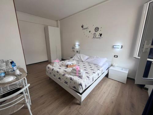 a small bedroom with a bed with dolls on it at Affittacamere Il Veliero in Levanto
