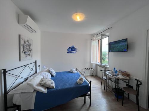 a bedroom with a bed and a table and a television at Affittacamere Il Veliero in Levanto