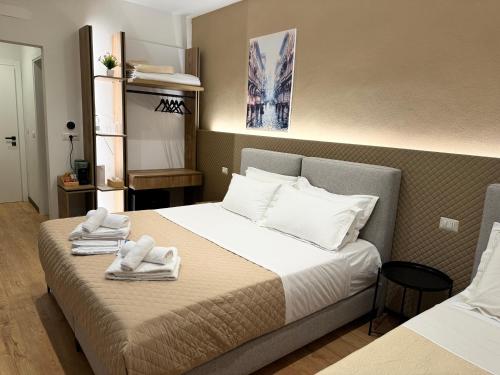 a hotel room with a bed with towels on it at Brianza Home in Giussano