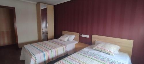 a hotel room with two beds next to each other at Nuria's home in Calanda