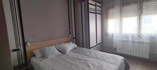 a bedroom with a large bed with a window at Nuria's home in Calanda