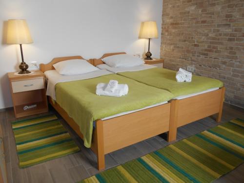 a bedroom with a large bed with towels on it at Apartment Ana in Zadar