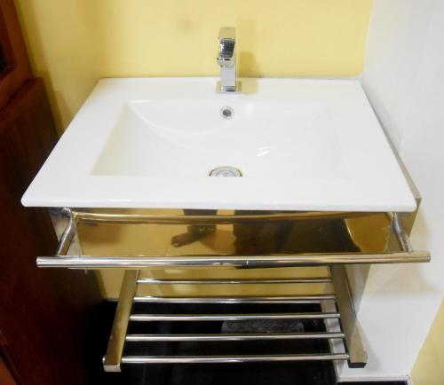 a white sink on a shelf in a bathroom at Train View Villa in Nanu Oya