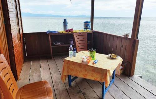 a table on the deck of a boat on the water at ParfrayHomestay Raja ampat in Besir