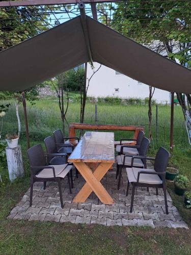 a wooden table and chairs under a tent at Plav`s dream in Plav