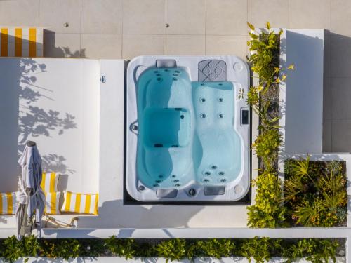 a pool at a resort with two water slides at Patricia Suites in Faliraki