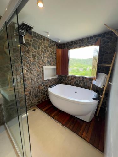 a bath tub in a bathroom with a window at Morada Santo Antônio in Piranhas