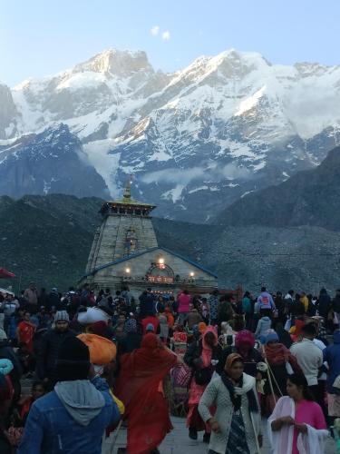 a crowd of people standing in front of a mountain at Hotel New Sunrise in Phata