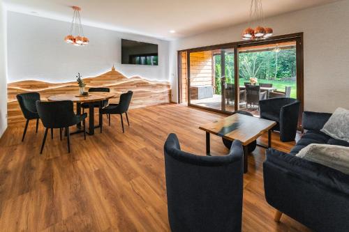 a living room with a couch and a table and chairs at Luxapart Golf Ostravice in Ostravice