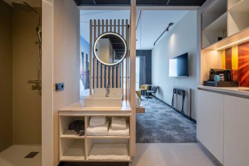 a bathroom with a sink and a mirror at Hotel Waterstate in Goes