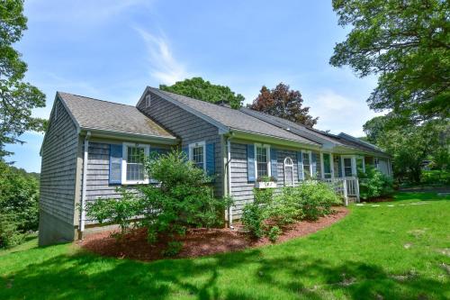 a house with a green lawn in front of it at Waterfront Incredible Views and Private Dock in Yarmouth