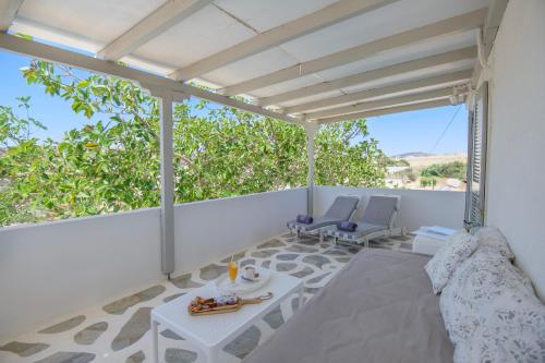 a patio with a table and chairs on a balcony at Margarita Studios Ambelas in Ambelas