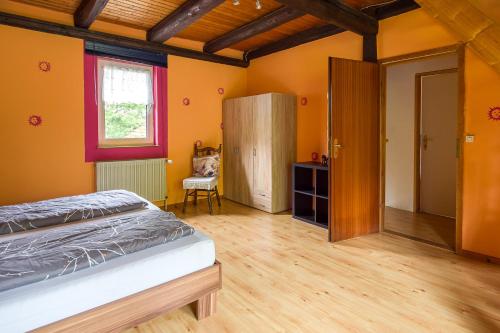 a bedroom with a bed and a wooden floor at Forsthaus Halbemark in Bad Sooden-Allendorf