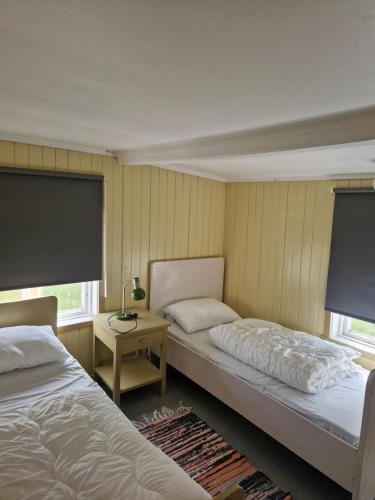 Postel nebo postele na pokoji v ubytování Åsenfjord, feriehus ved sjøen