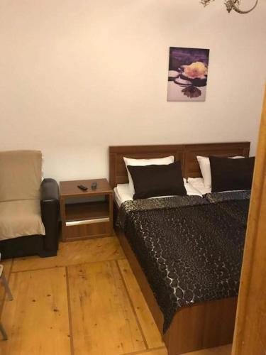 a bedroom with a bed and a side table at Karakum Villa in Ureki