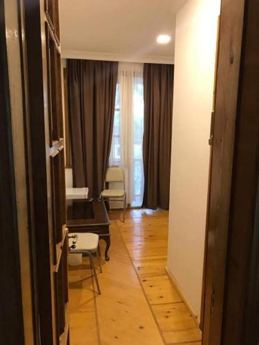 a hallway with a living room with a table and chairs at Karakum Villa in Ureki