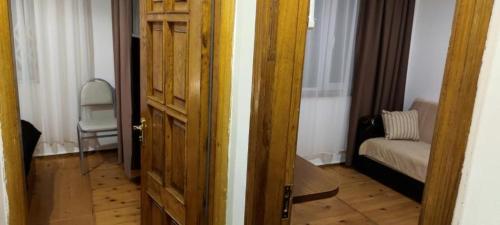an open door to a room with a chair and a bedroom at Karakum Villa in Ureki