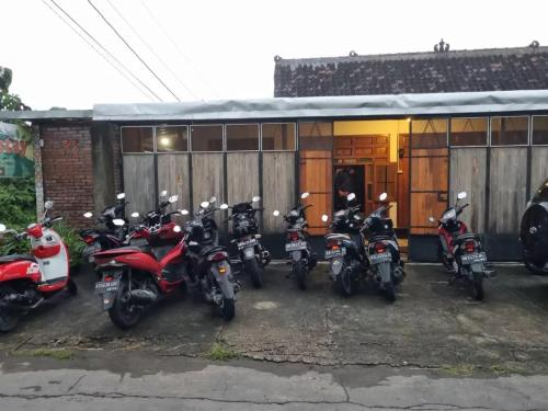 a group of motorcycles parked in front of a building at Bayt Assalaam Syariah Homestay in Klaten