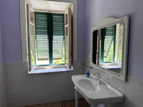 a bathroom with a sink and two mirrors at Paradiso verde in Lucca