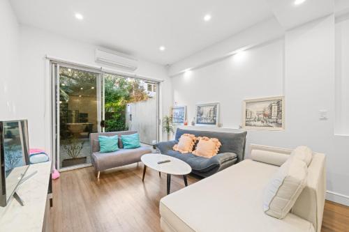 a living room with a couch and a table at Oasis Fish Market 4BR House&DarlingHarbour& ICC-8 mins in Sydney