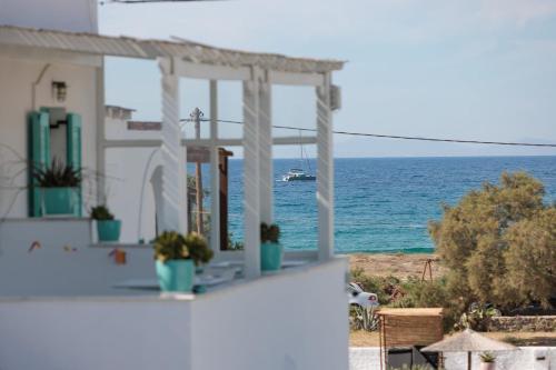 a view of the ocean from a balcony of a house at Naxos Cave Suites in Stelida