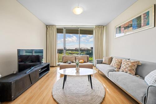 a living room with a couch and a table at Central CBD 3BR Apt - 150m to Darling Harbour & ICC in Sydney