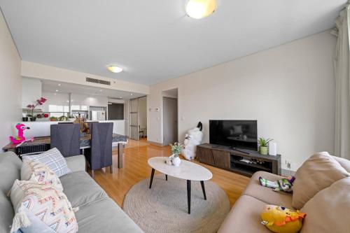 a living room with a couch and a table at Central CBD 3BR Apt - 150m to Darling Harbour & ICC in Sydney