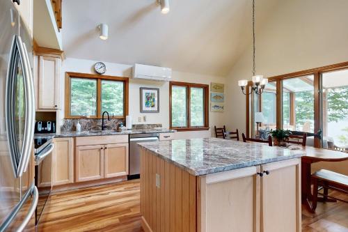 a kitchen with a refrigerator and a counter top at Meadow Cove in Boothbay