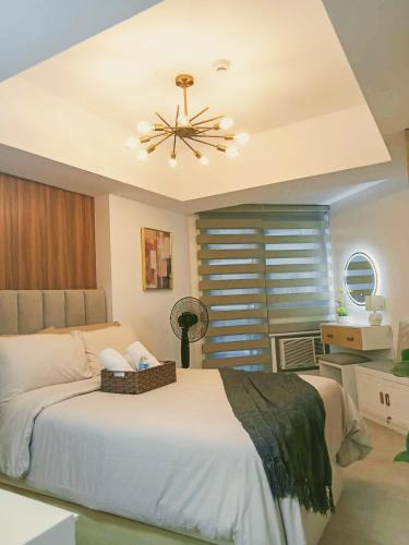 a bedroom with a bed and a ceiling fan at Sam's Chic Space - An Aesthetic Getaway in Angeles
