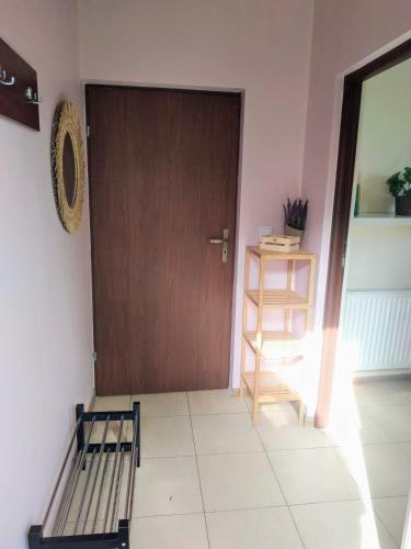 a room with a door and a bed and a shelf at Apartamenty Górki Małe in Tuszyn