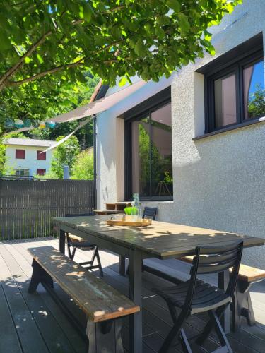 a picnic table and benches on a patio at MAISON FAMILIALE 3 ch. au CENTRE D'AX in Ax-les-Thermes